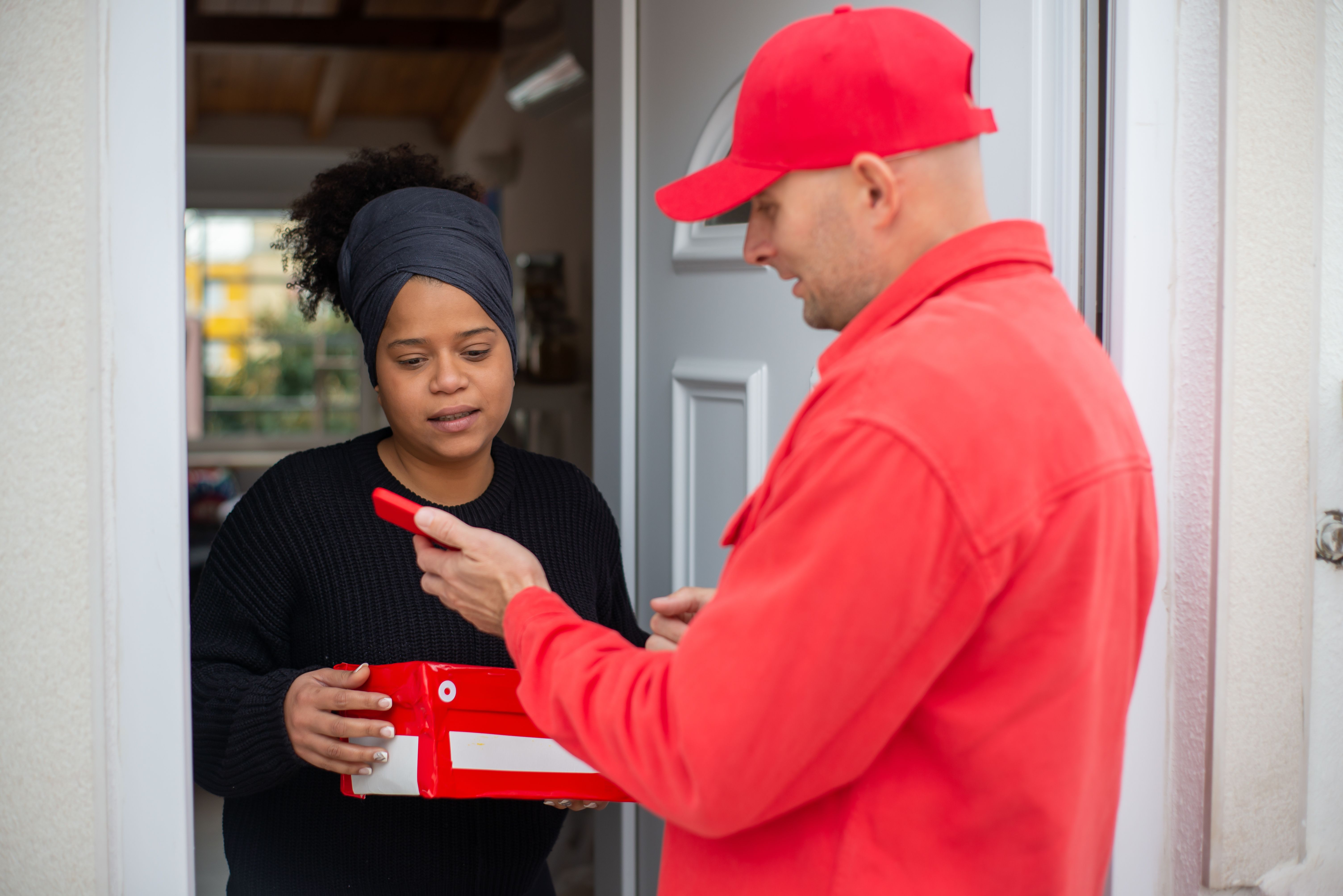 Courier handing a package to a customer